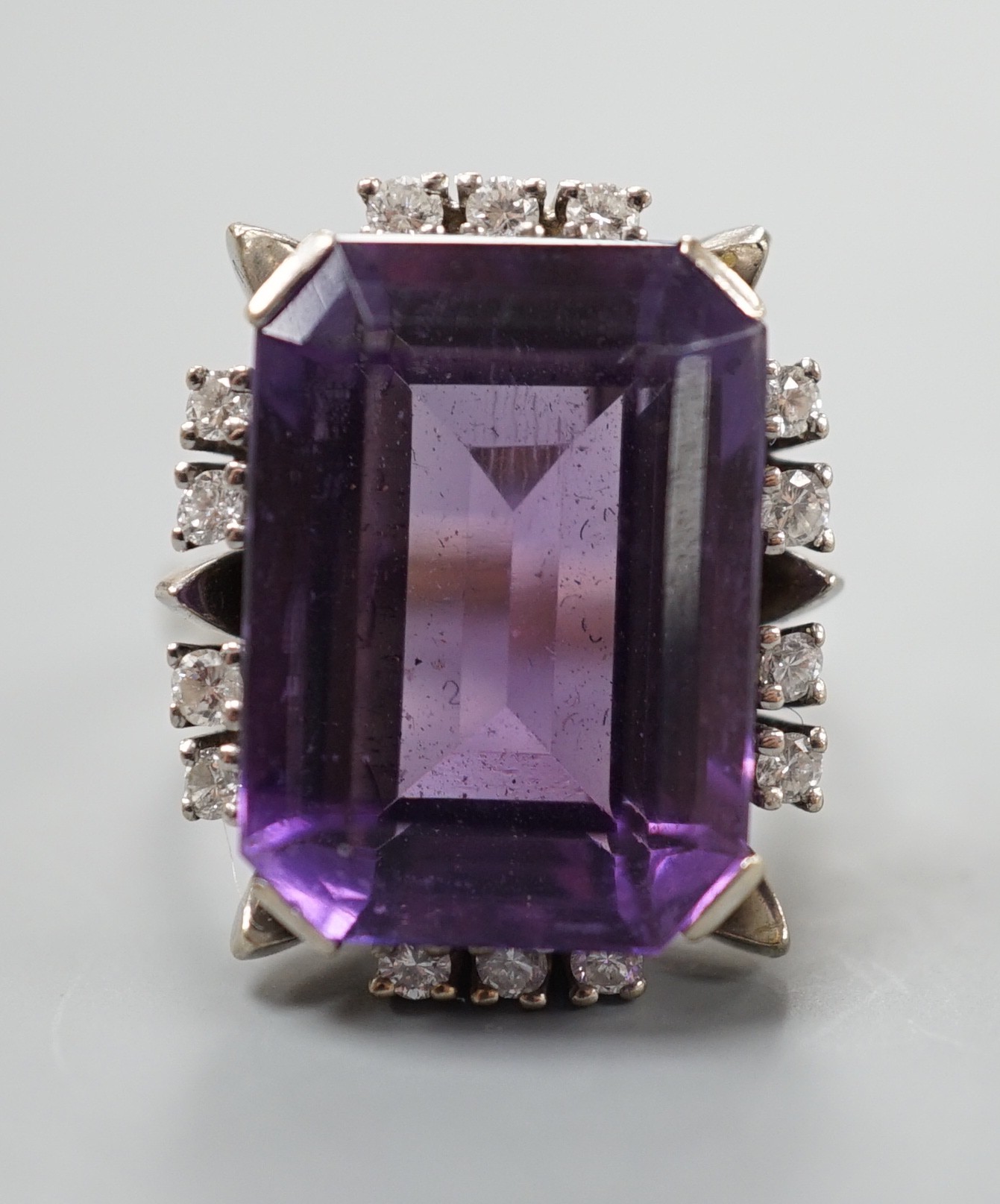 A 585 white metal emerald cut amethyst and diamond set cluster ring, size L, gross weight 11.5 grams.